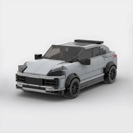Gray toy car model made from building blocks with black wheels and tinted windows
