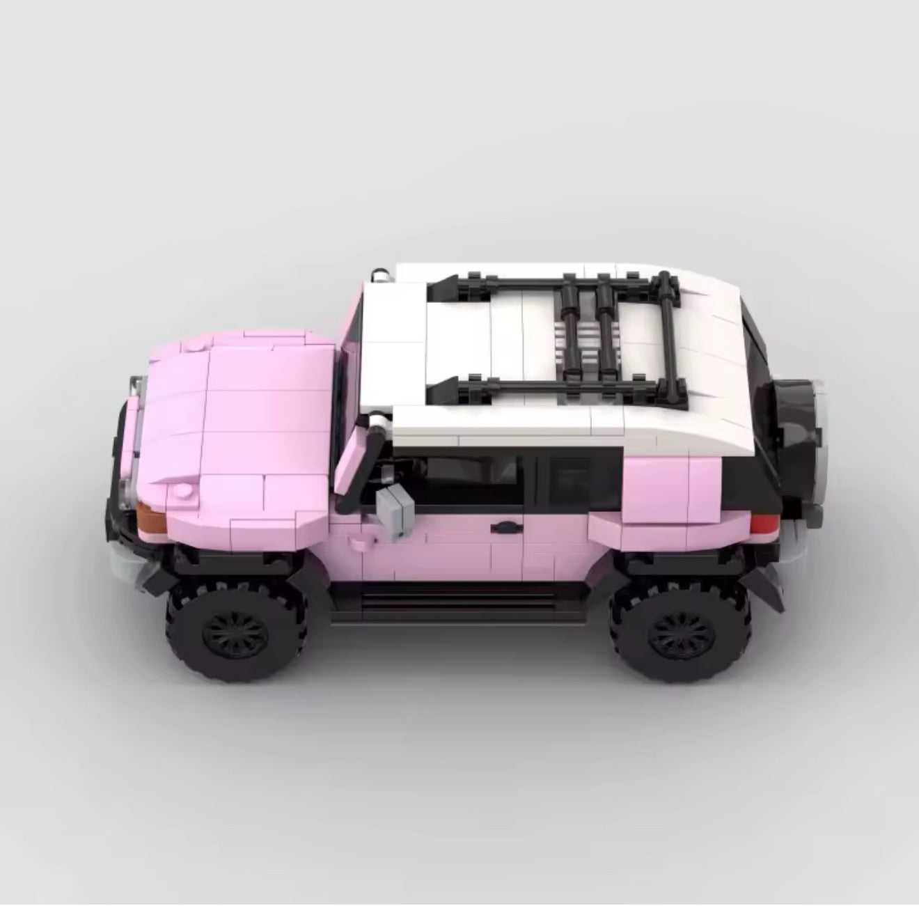 Pink Toyota FJ Cruiser toy model by RevvBlox, detailed miniature vehicle with realistic features and vibrant color.