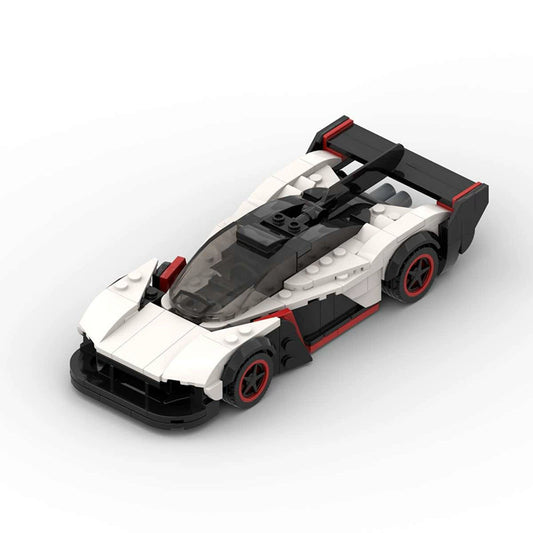 RevVBlox Aston Martin Valkyrie model car resting on a display stand, showcasing detailed design and sleek aerodynamic features.