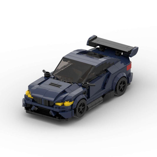 Dark blue LEGO model of a sports car with rear spoiler and tinted windshield on white background