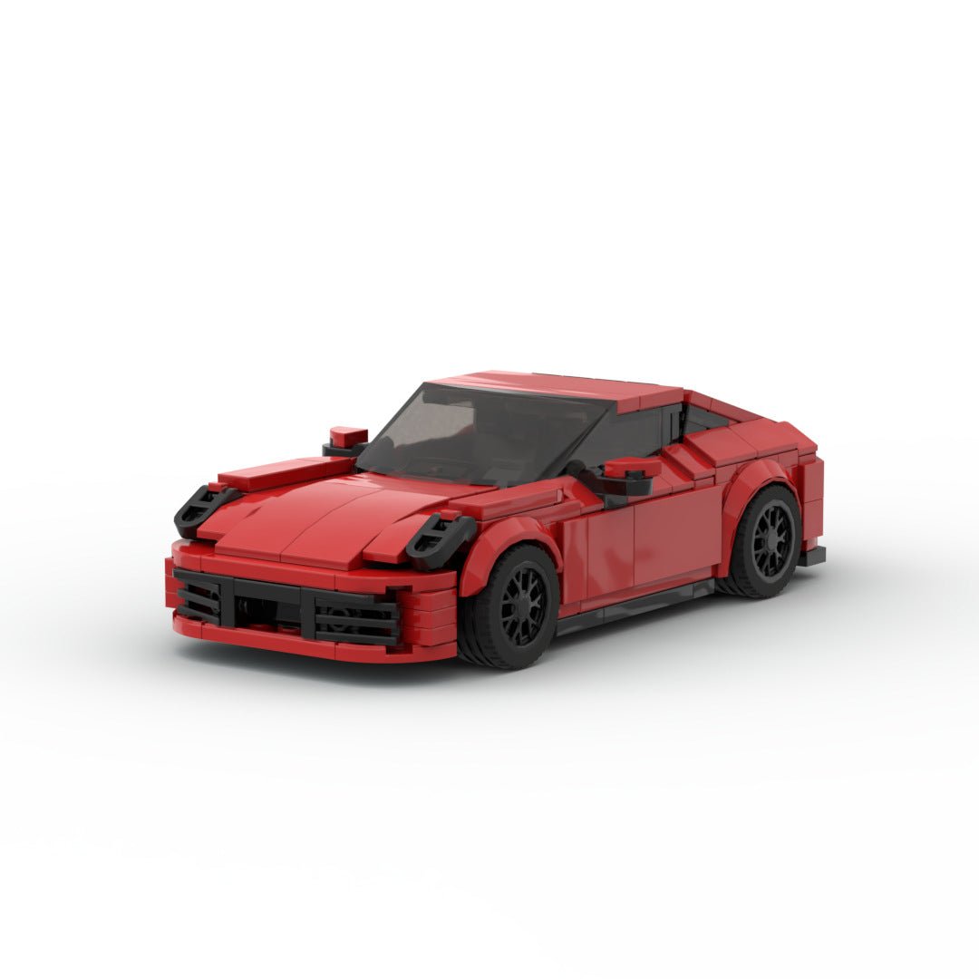 Red LEGO model of a Porsche 911 Carrera with black wheels on white background