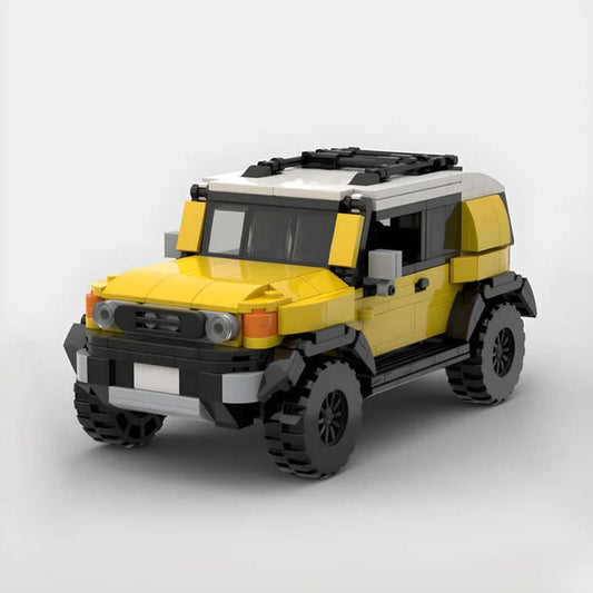 Yellow and white LEGO Toyota FJ Cruiser model with off-road tires on white background