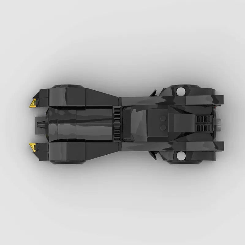 RevvBlox Batman car toy with detailed black and yellow design, featuring Bat emblem and sporty vehicle shape.