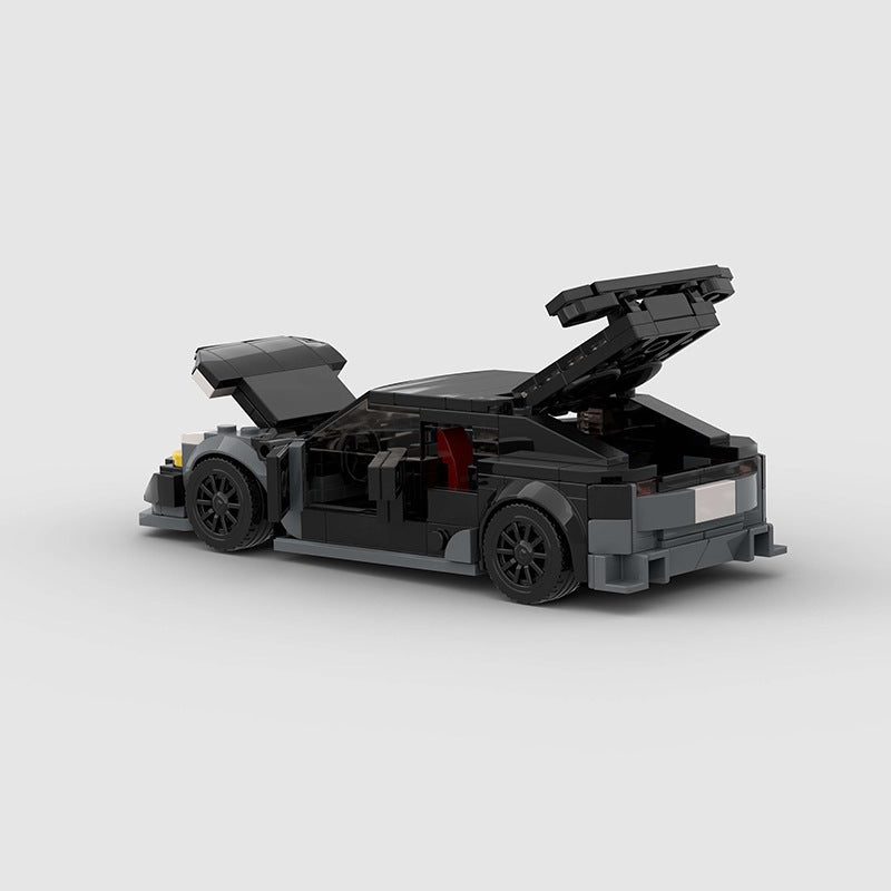 RevvBlox Tesla Model 3 Bionic toy car in orange with detailed exterior and realistic design, showcasing the miniature model.