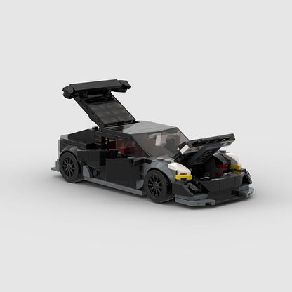 RevvBlox Tesla Model 3 Bionic LEGO-style building block set showing assembled car model with detailed exterior features.