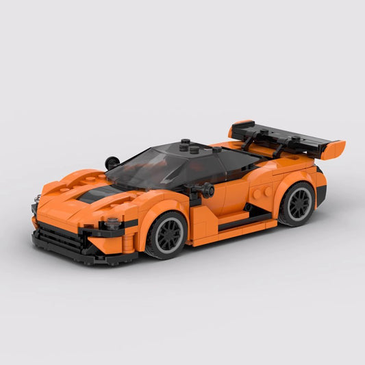 Orange and black LEGO sports car model with rear spoiler and sleek design on white background