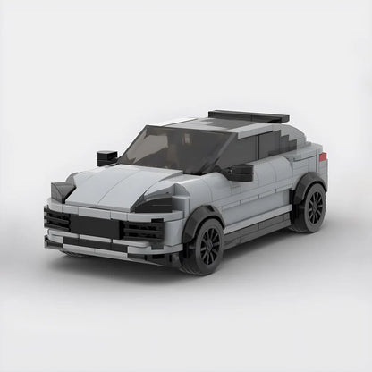 Gray toy car model made from building blocks with black wheels and tinted windows