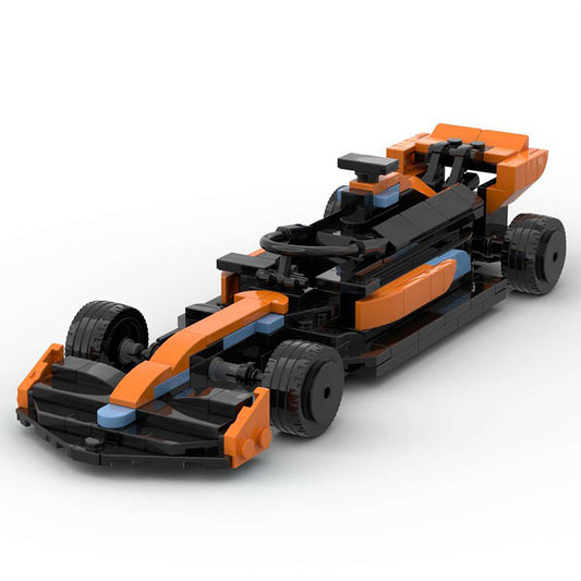 Black and orange LEGO race car model with front wing, steering wheel, and detailed tires