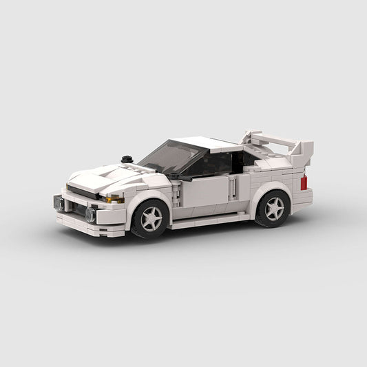 Revvblox Mitsubishi Lancer Evolution Gen V model car in detailed plastic, showcasing the sporty design and vibrant color.