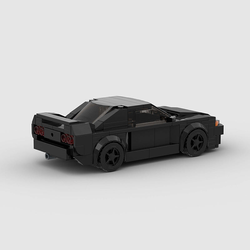 RevVBlox Nissan Skyline GT-R R32 "Takeshi" Initial D diecast model car, detailed black and silver design, front and side view.