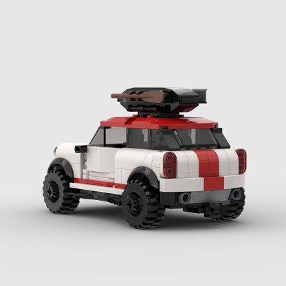 White and red toy car with large tires and a mounted cannon on the roof, isolated on light background