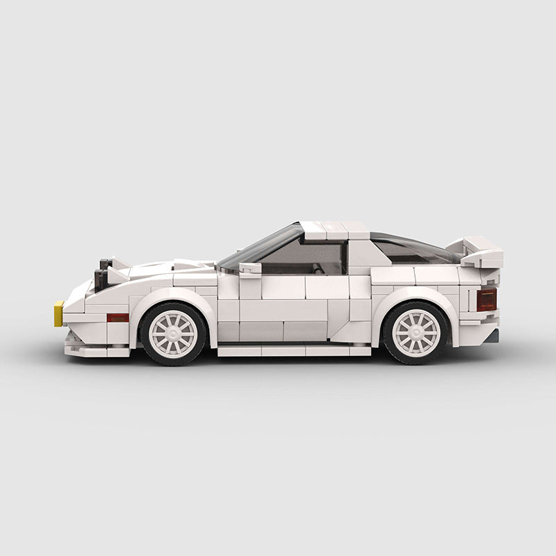 RevVBlox Mazda RX-7 FC3S model car in detailed white with orange accents, showcasing the classic sports car design.
