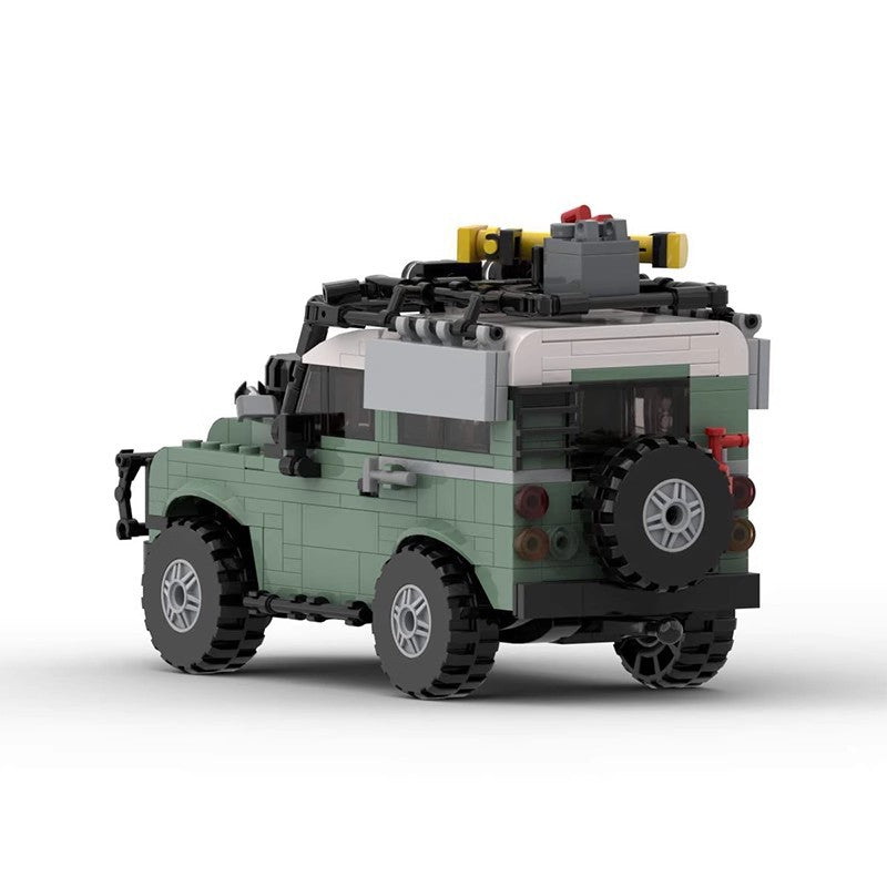 LEGO model of a green and white off-road SUV with roof rack and spare tire on rear