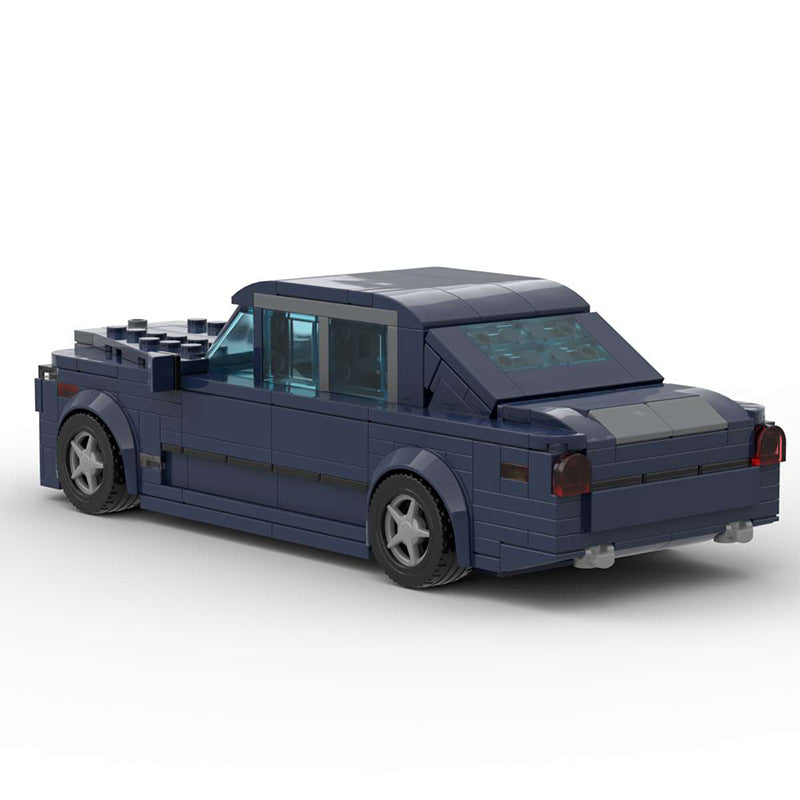 Dark blue LEGO model of a classic four-door sedan with tinted windows and detailed wheels