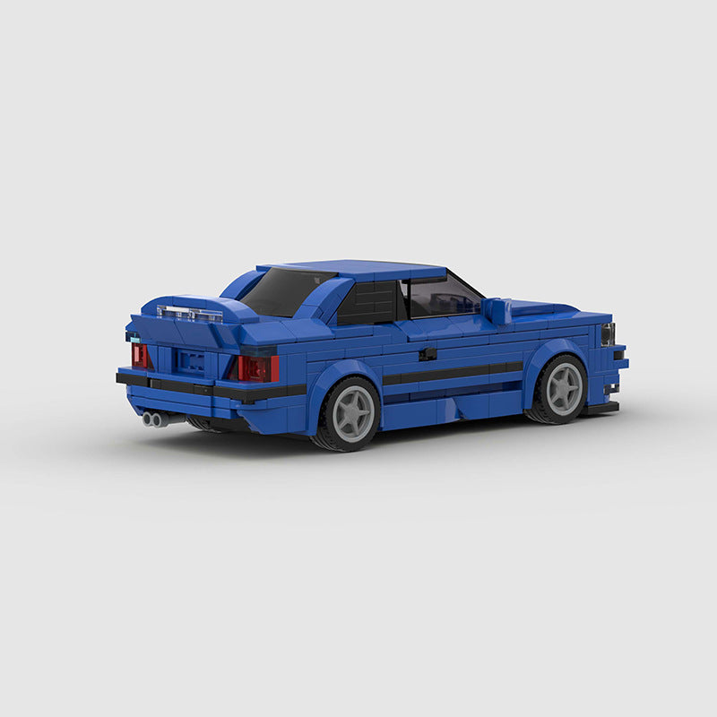 RevvBlox BMW M3 E36 model car in detailed blue plastic with black accents, showcasing realistic design and craftsmanship.