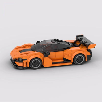 Orange and black LEGO sports car model with rear spoiler and detailed design on gray background