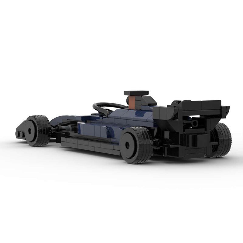 Black and dark blue LEGO race car model with rear spoiler on white background