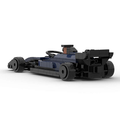Black and dark blue LEGO race car model with rear spoiler on white background