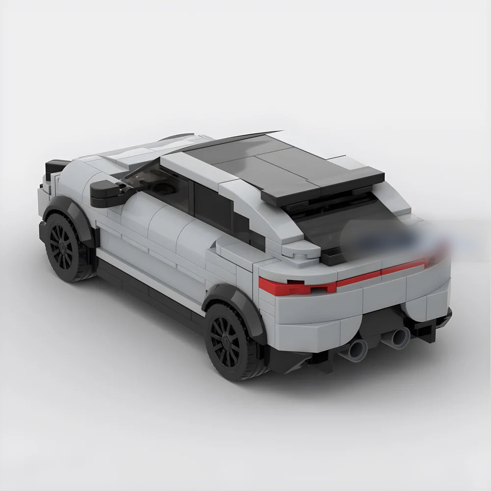 Rear side view of a white and black toy car model made from building blocks on a white background