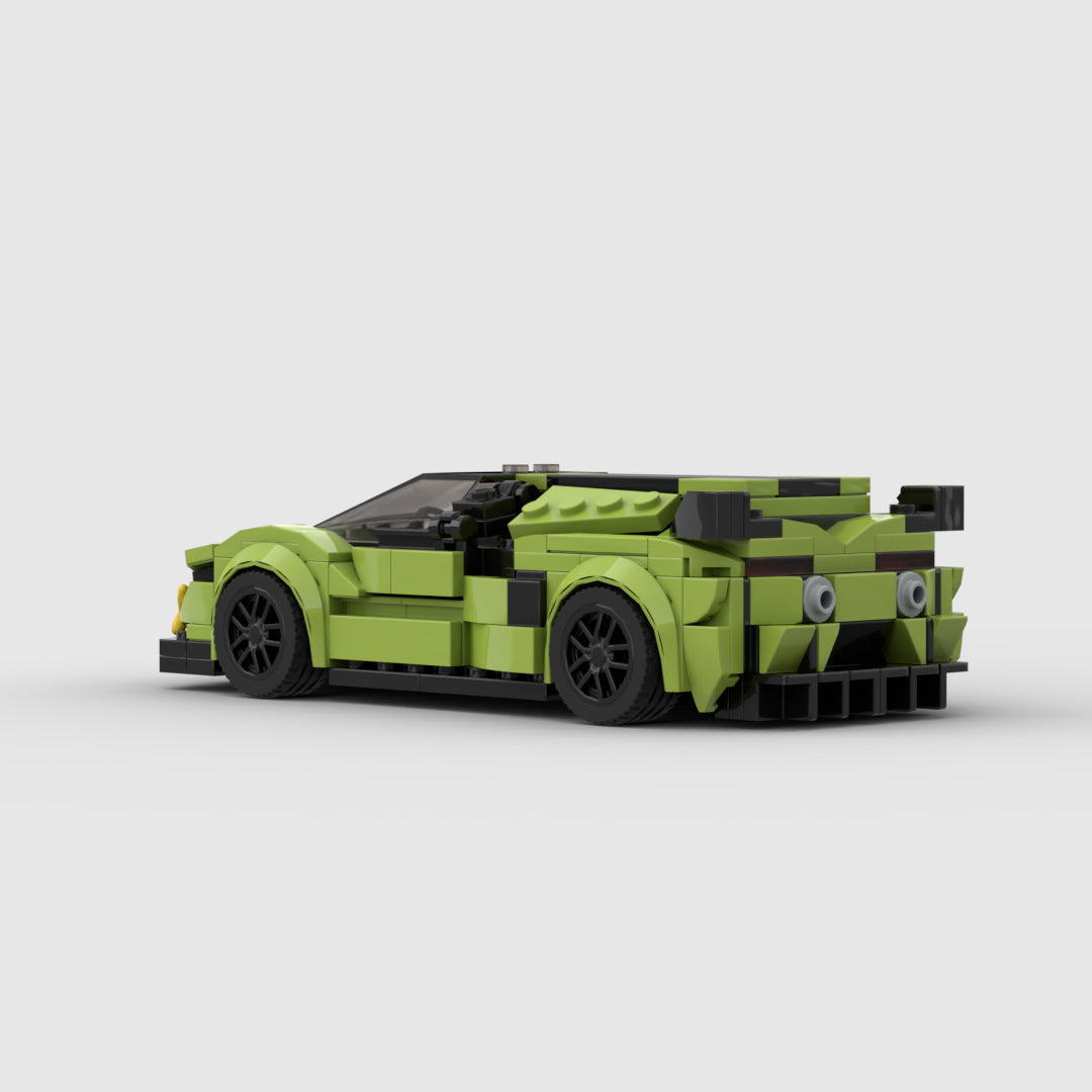 Green LEGO sports car model with black wheels and rear spoiler on white background