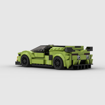 Green LEGO sports car model with black wheels and rear spoiler on white background