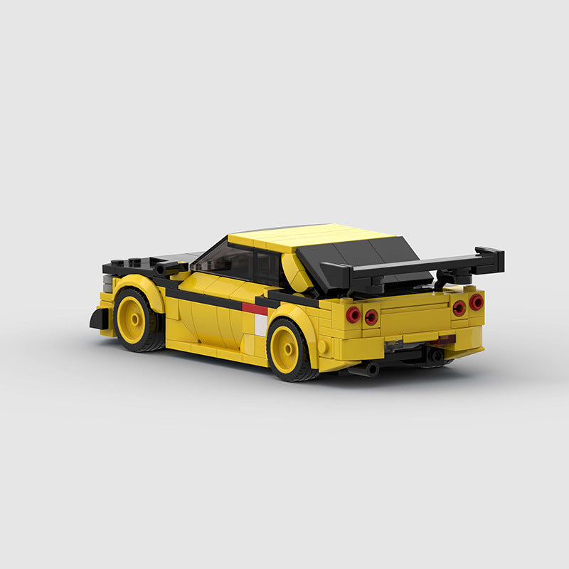 RevVBlox Nissan GT-R R34 model car with detailed blue and silver design, showcasing intricate exterior features and realistic proportions.