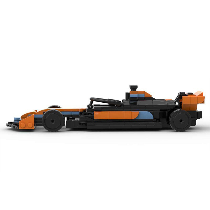 Side view of an orange and black LEGO race car model with blue accents on white background