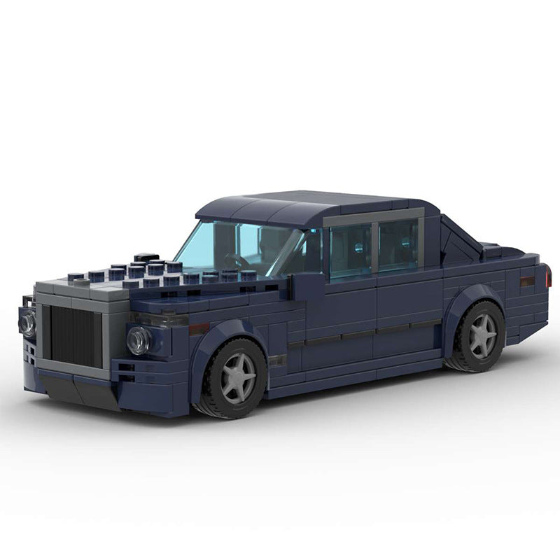 Dark blue LEGO model of a luxury sedan car with detailed wheels and translucent windows