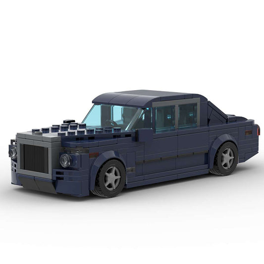 Dark blue LEGO model of a luxury sedan car with detailed wheels and translucent windows