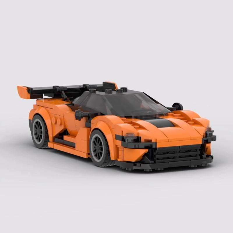 Orange and black sports car model built from interlocking plastic bricks with large rear spoiler