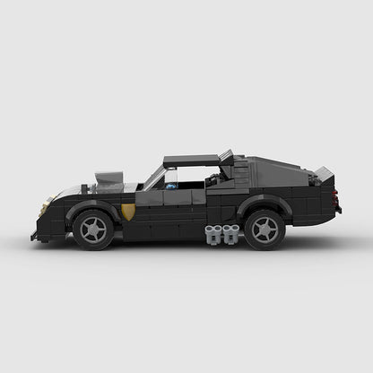Detailed close-up of the RevvBlox 1973 Ford Falco Mad Max V8 Interceptor model showing engine, bodywork, and rugged design features.