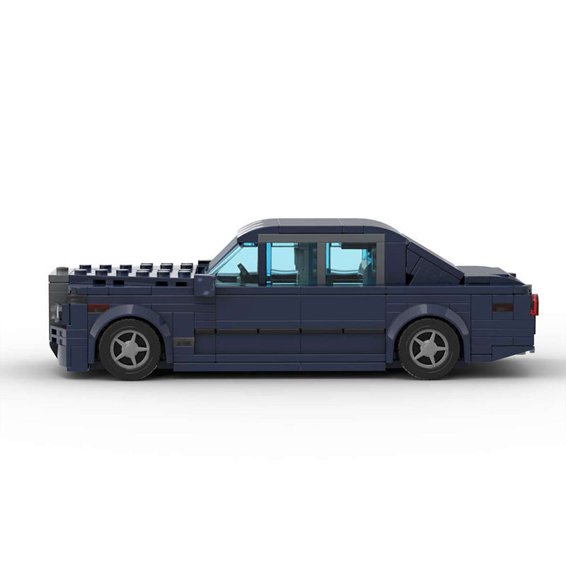 Dark blue LEGO model of luxury sedan car with tinted windows on white background