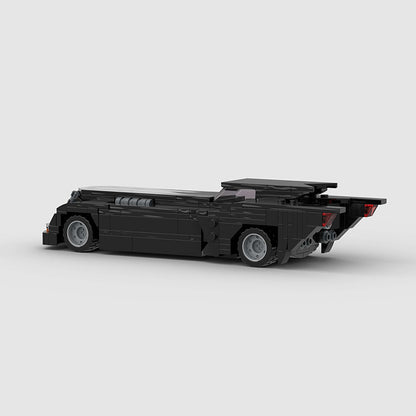 RevVBlox Batmobile toy model with detailed black and red design, showcasing a sleek, futuristic vehicle for Batman fans.