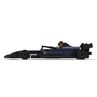 Dark blue LEGO model of a Formula 1 race car with detailed bodywork, tires, and rear wing