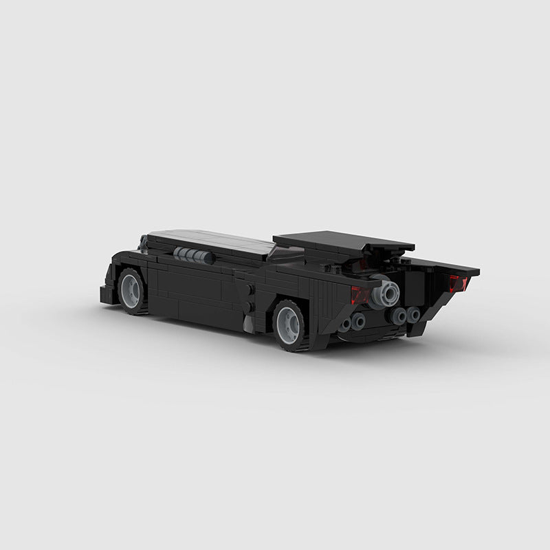 RevvBlox Batmobile toy model with detailed black and gray design, shown from a side angle on a white background.