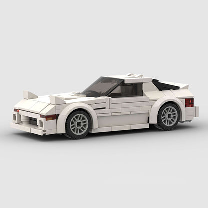RevvBlox Mazda RX-7 FC model car in white with detailed exterior and sleek sporty design on a plain background.