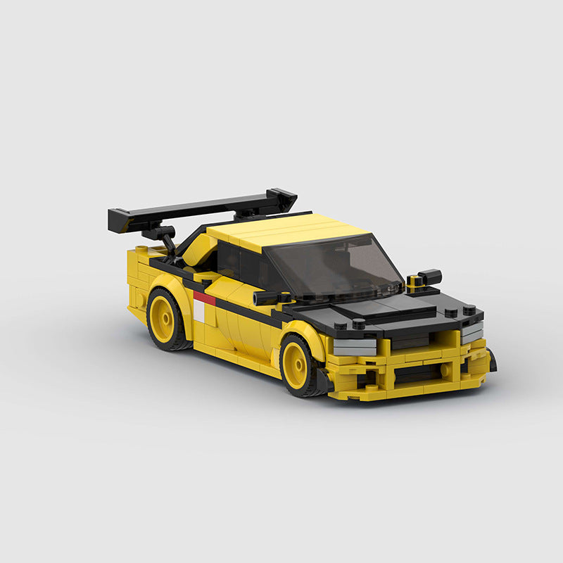 RevvBlox Nissan GT-R R34 model car in gray with detailed exterior and aerodynamic design, shown from a side angle.