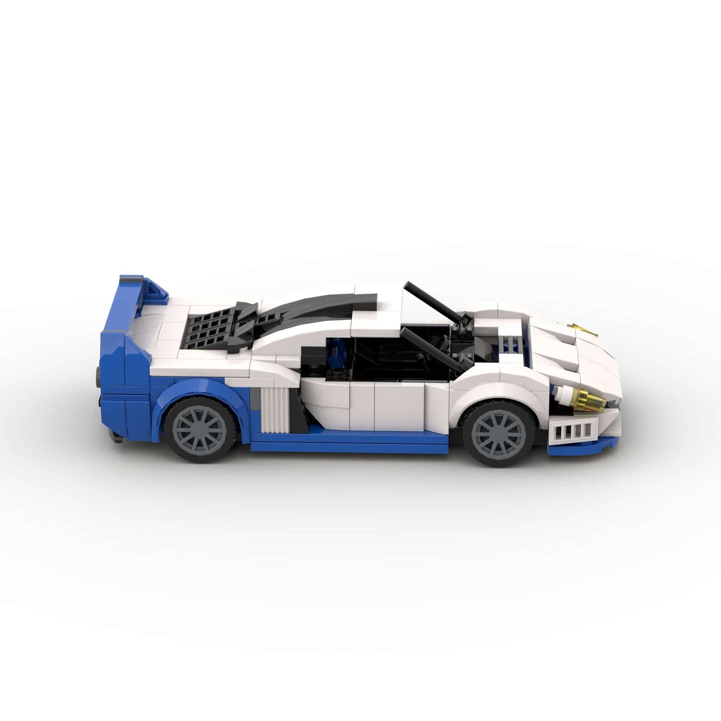 RevvBlox Maserati MC12 model car in detailed plastic construction with sleek silver and blue design.