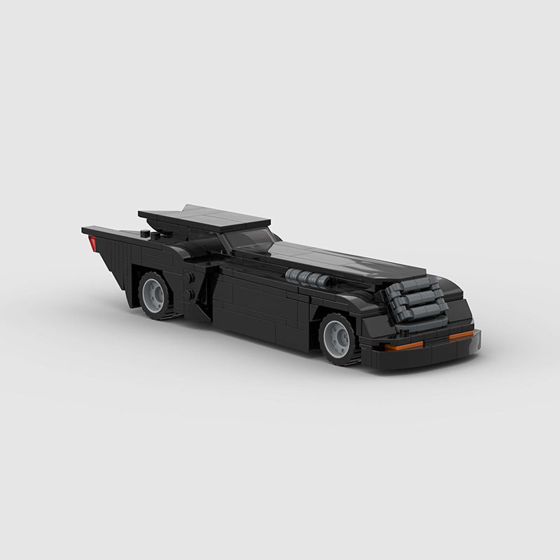 RevVblox Batmobile toy model with detailed black and gray design, sleek profile, and iconic Batmobile features.