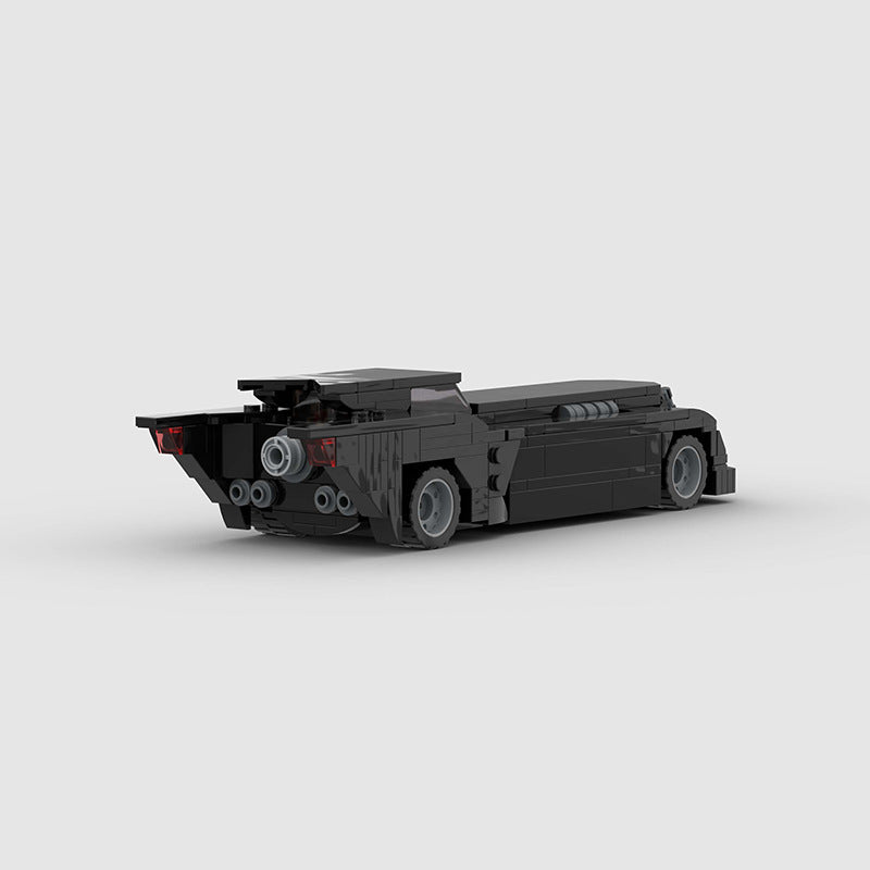 RevvBlox Batmobile toy model with detailed black and gray design, featuring sleek lines and aerodynamic shape.