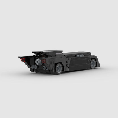 RevvBlox Batmobile toy model with detailed black and gray design, featuring sleek lines and aerodynamic shape.