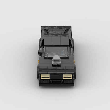 RevvBlox 1973 Ford Falcon Mad Max V8 Interceptor die-cast model car with detailed black and orange design.