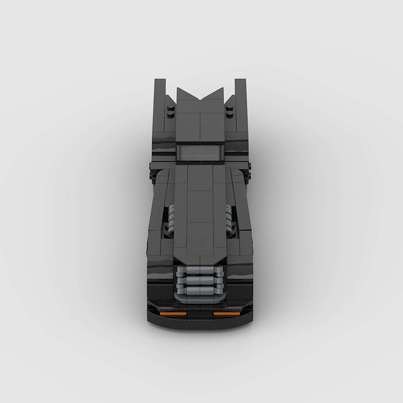 RevvBlox Batmobile toy model with detailed black and gray design, featuring sleek curves and Batmobile branding.