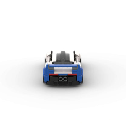 RevVBlox Maserati MC12 model car with detailed red and white design, showcasing aerodynamic curves and intricate features.