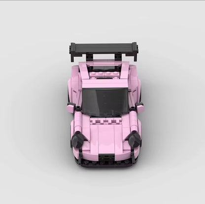Porsche 911 GT3 in pink by RevvBlox, showcasing sleek design and aerodynamic features against a clean background.
