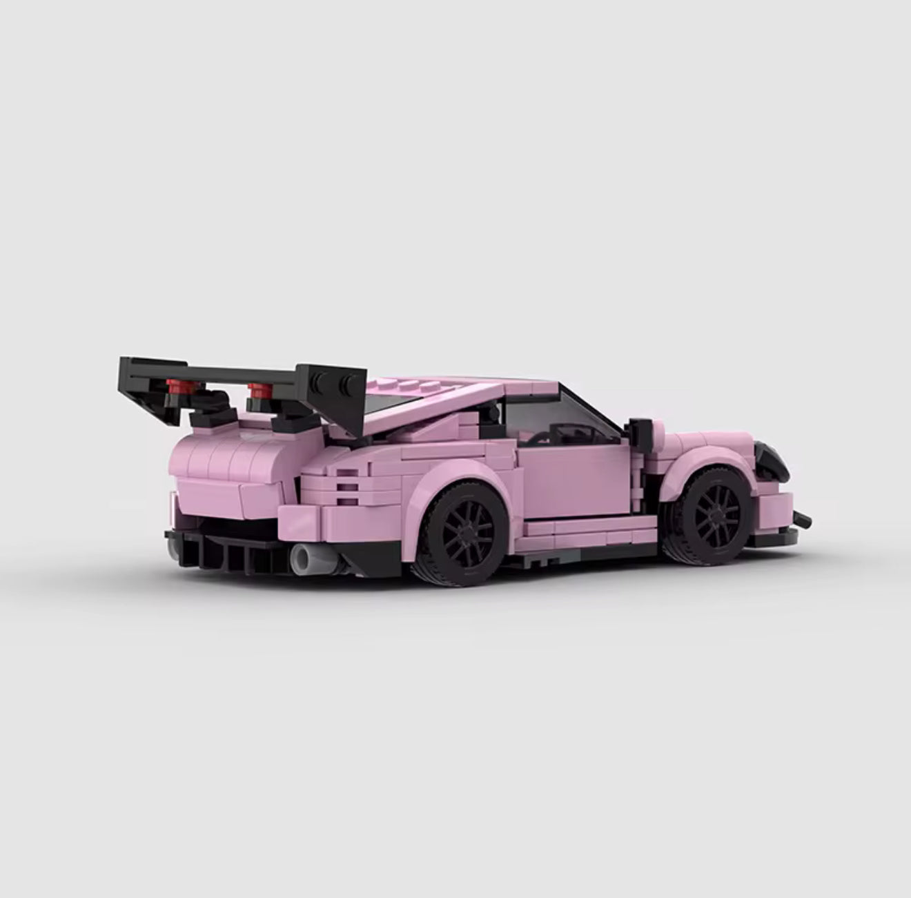 Porsche 911 GT3 in pink from RevvBlox, showcasing sleek design and sporty features against a neutral background.