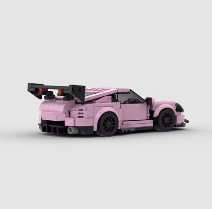 Porsche 911 GT3 in pink from RevvBlox, showcasing sleek design and sporty features against a neutral background.