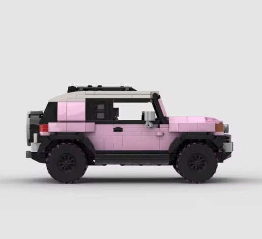 Pink Toyota FJ Cruiser toy model by RevvBlox, detailed miniature vehicle with realistic features and vibrant color.