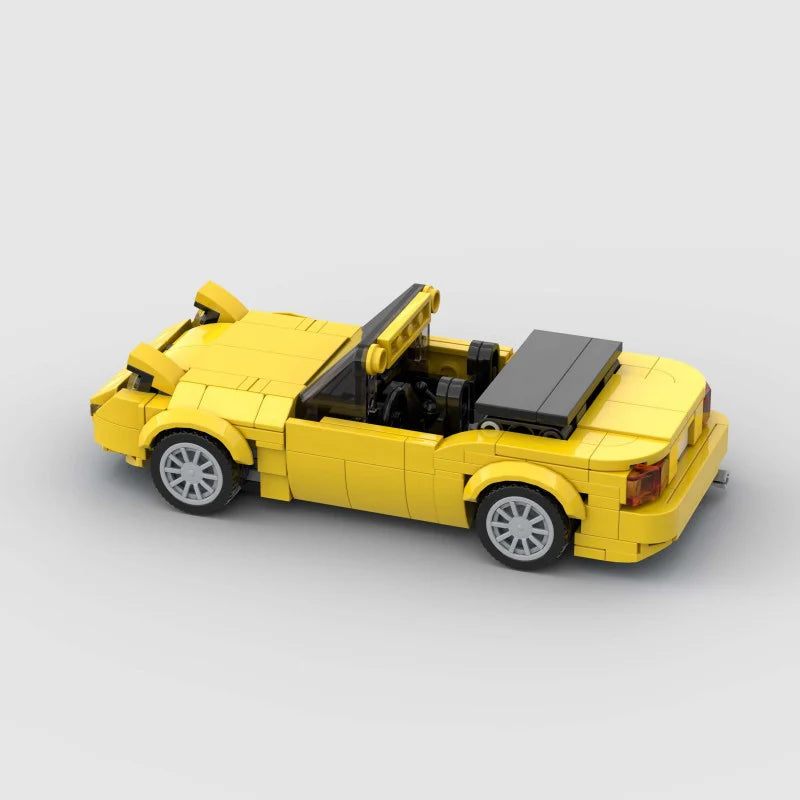 RevvBlox Mazda Miata MX-5 model car in gray with detailed exterior and interior features, showcasing a miniature replica.