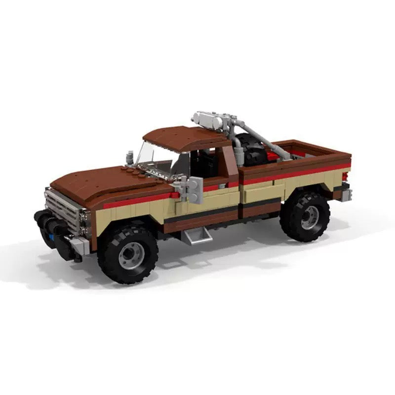 RevvBlox Fall Guy pickup truck toy with detailed design, featuring a red and black color scheme and realistic truck features.